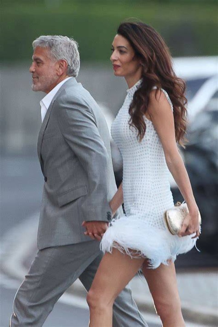 Amal Clooney Stuns In Ostrich Feather Dress Holding Hands With George In Lake Como: Photos