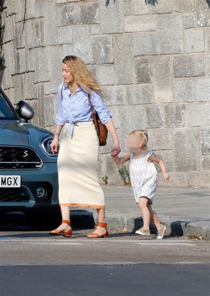 Amber Heard Cuddles Mini-Me Daughter, 10 Months, In Rare Photo