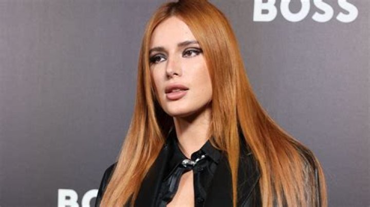 Bella Thorne Wears Nothing But An Open Velvet Vest & Matching Pants In Sexy New Photos