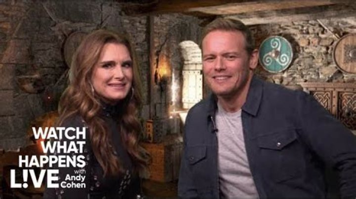 Brooke Shields & Sam Heughan Reenact Steamy ‘Outlander’ Season 3 Love Scene On ‘WWHL’ — Watch