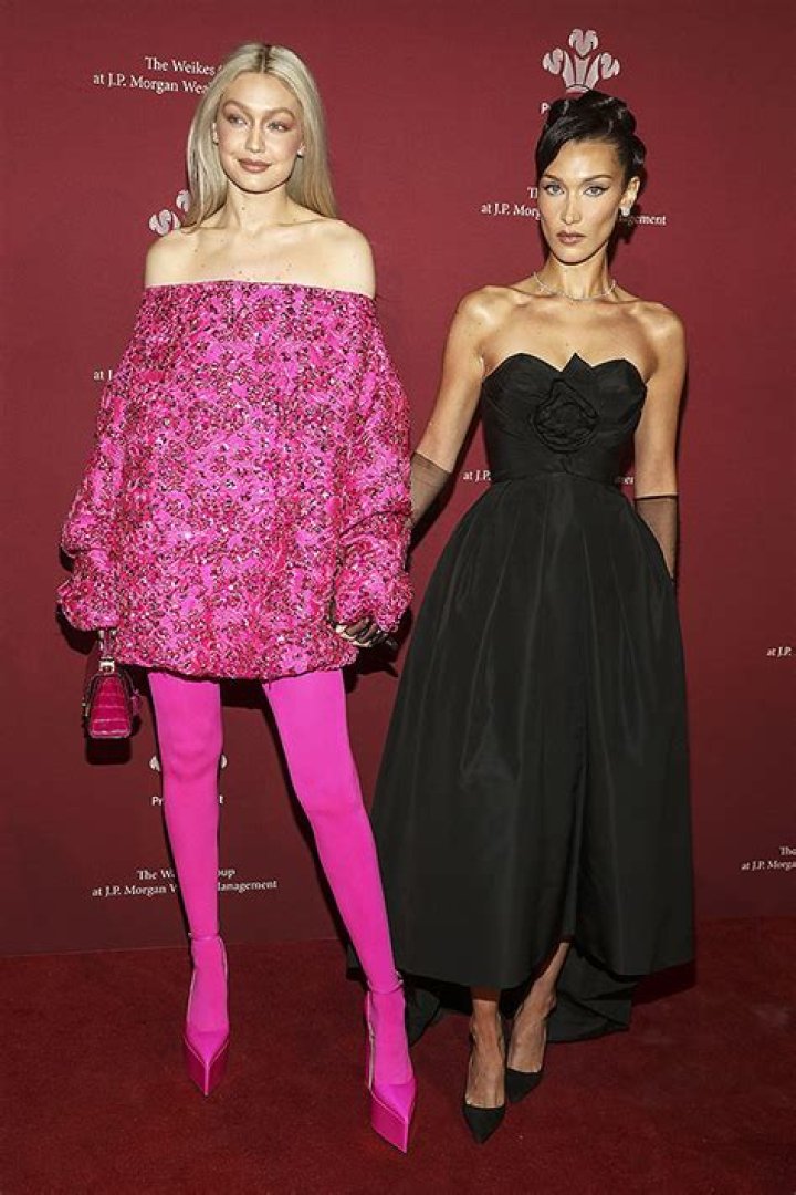 Gigi & Bella Hadid Hold Hands In Hot Pink & Black Outfits At The Prince’s Trust Gala