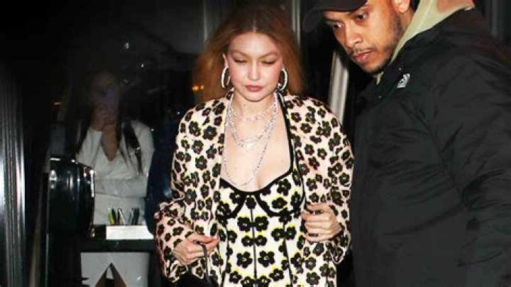 Gigi Hadid Stuns In Skintight Floral Jumpsuit & Matching Coat During Paris Fashion Week