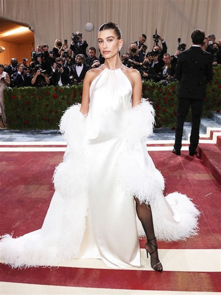 Hailey Bieber Echoes Disco Glamour In Satin White Dress With Feathers – Hollywood Life