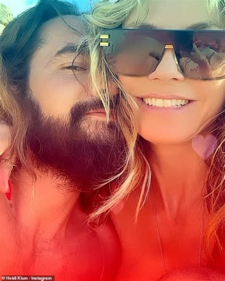 Heidi Klum Kisses Husband Tom Kaulitz Through A Glass As They Await COVID-19 Test Results