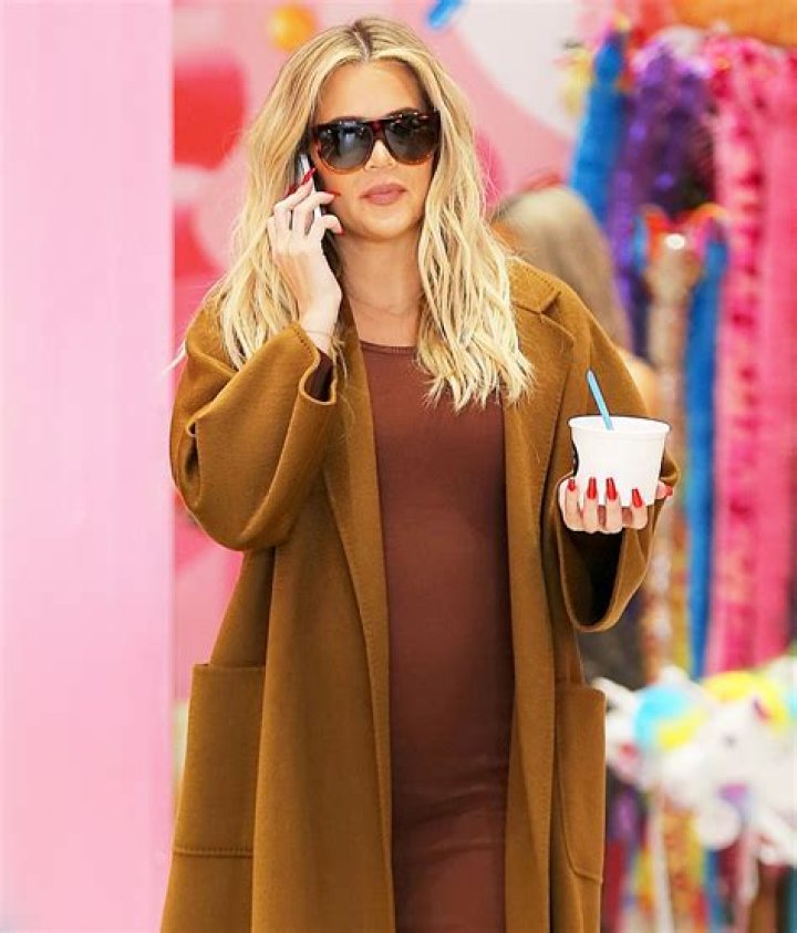 Khloe Kardashian Shows Off Baby Bump In Tight White Dress Just Like Sis Kim Kardashian