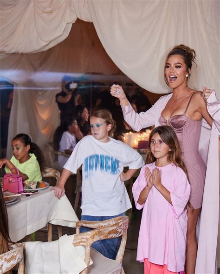 Kourtney Kardashian Wears Pink Wetsuit & Cuddles Daughter Penelope, 10, On A Boat: Photos