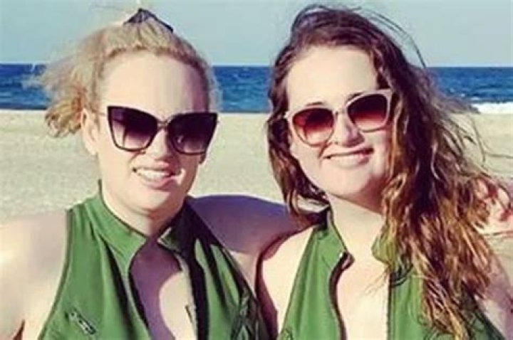 Rebel Wilson’s Plunging Purple Swimsuit & Wrap Skirt – Photos – Hollywood Life