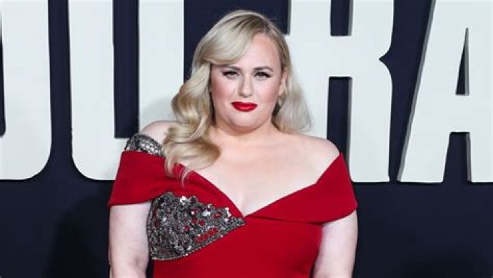Rebel Wilson Slays In Plunging Dress & Red Clingy Gown After 60 Lb. Weight Loss & Jacob Busch Split