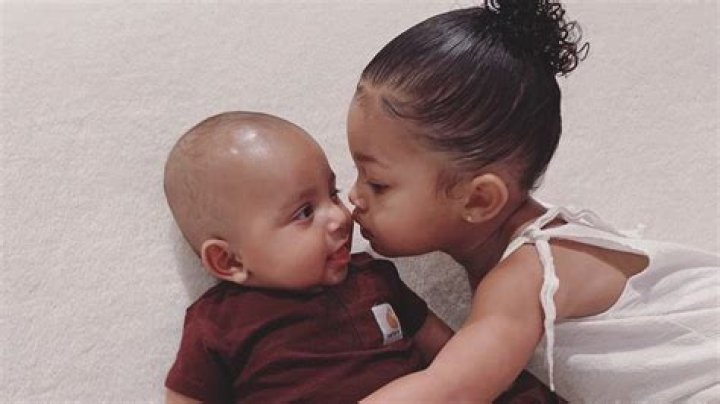 Stormi Webster, 1, Sweetly Kisses Cousin Psalm West, 8 Mos. — See Cute Photo