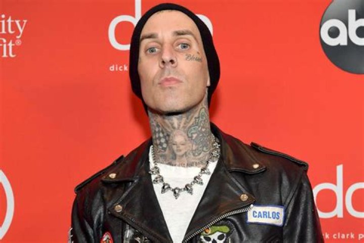 Travis Barker Looks Unrecognizable With Grey Wig & Glasses In MGK’s Music Video