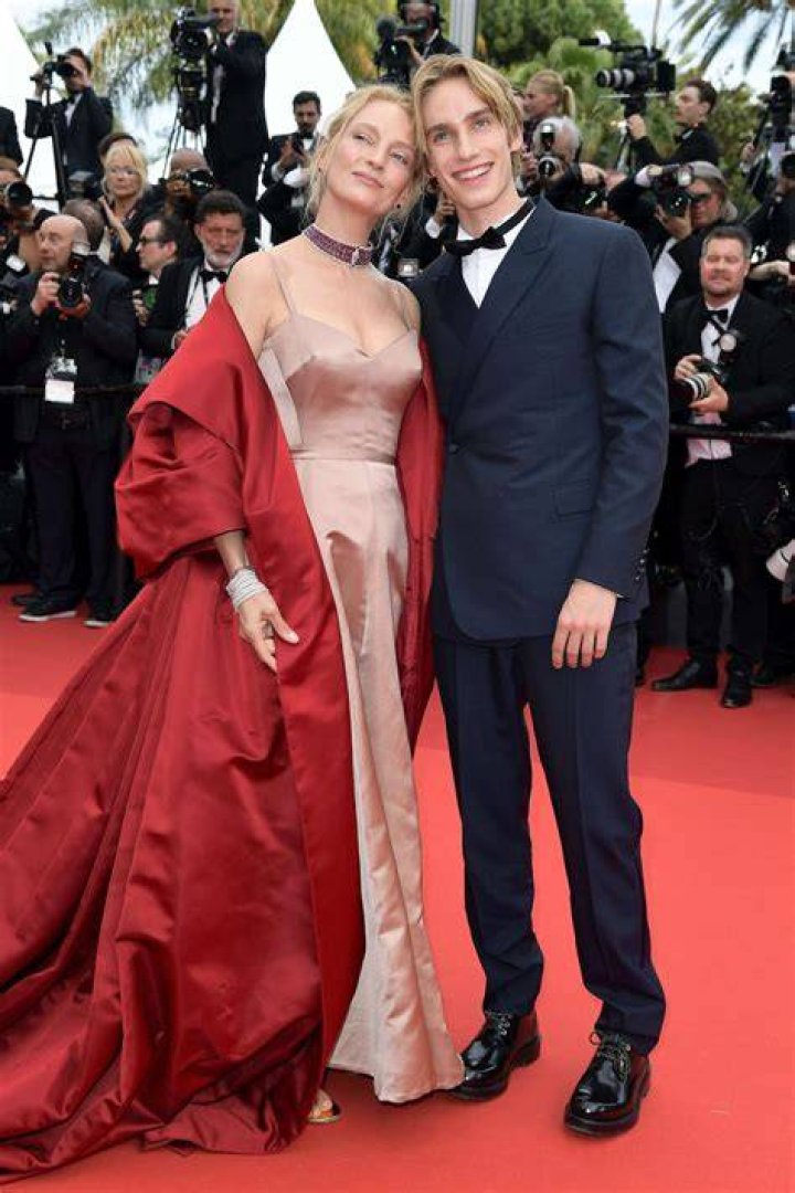 Uma Thurman, 49, & Ethan Hawke’s Son, Levon, 18, Towers Over His Mom At Paris Fashion Week